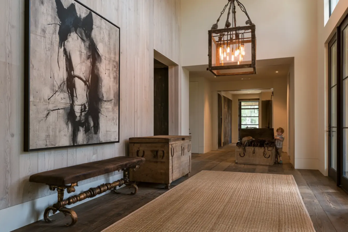 Natural jute rug on dark wooden flooring under antique metal pendant lighting in equestrian bedroom